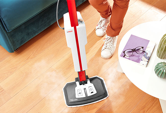L'image montre le nettoyeur vapeur Polti Vaporetto SV650 Style utilisé sur un sol en bois