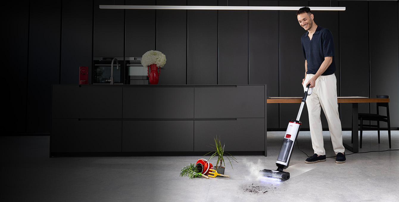 A girl using Polti Rollysteam cleaning the wood floor